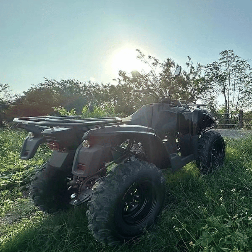 View of the back of the Novae electric all-terrain vehicle parked in a grassy area.